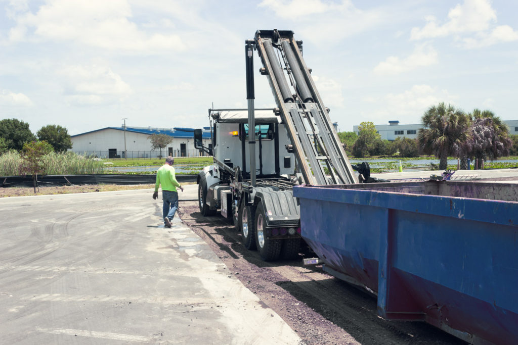 roll-off dumpster truck worker