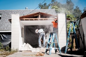 worker concrete saw garage demolition